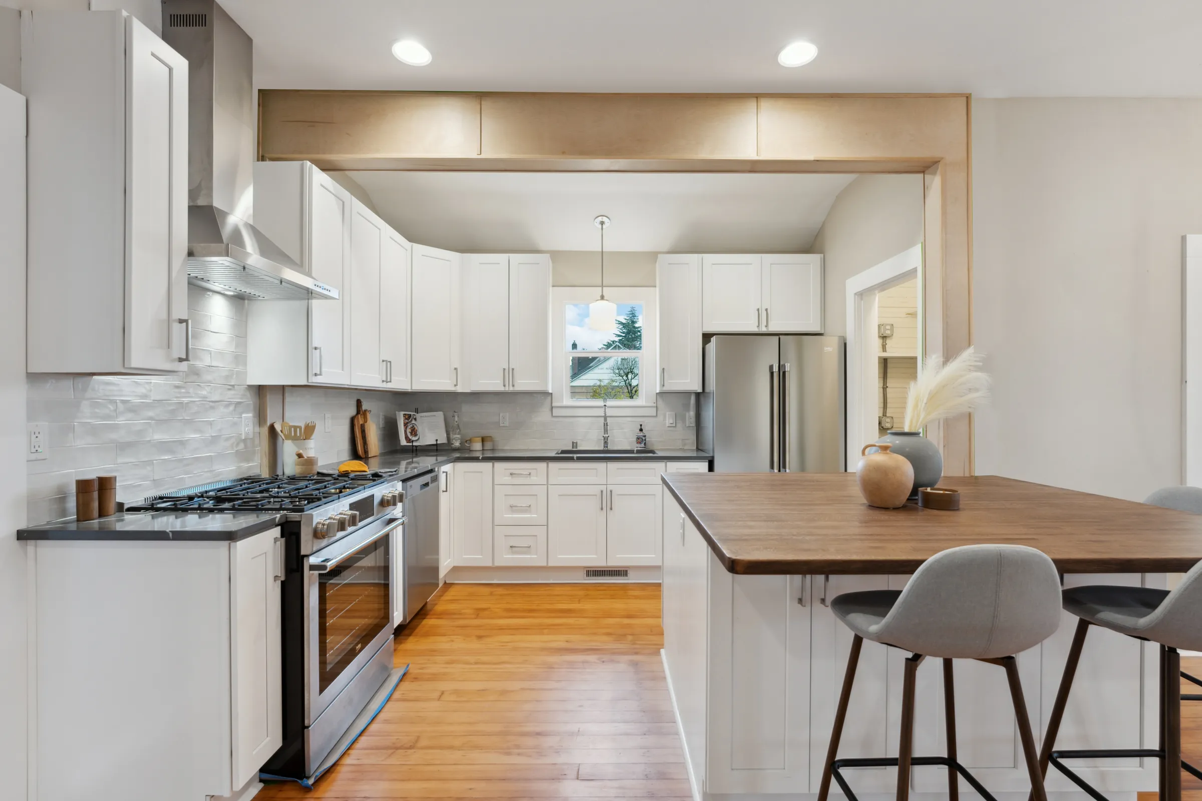 Kitchen remodel by CRM Services with white shaker cabinets and butcher-block island in Vancouver WA